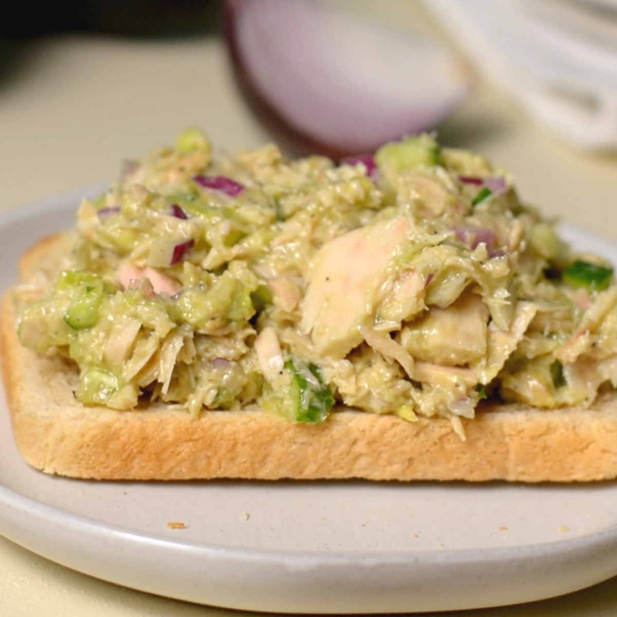 An open face avocado tuna sandwich.