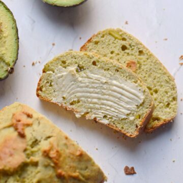 Two slices of avocado bread with butter spread on it.